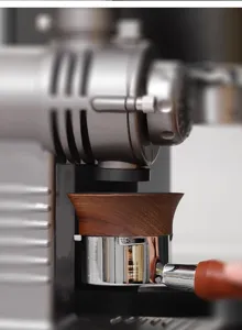 Walnut magnetic espresso dosing funnel detail, metal portafilter accessory close-up