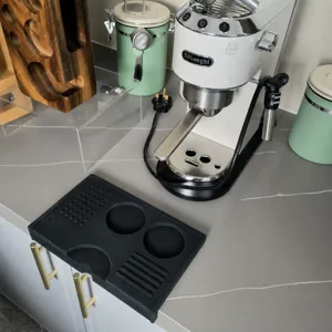 Black silicone coffee tamping mat, non-slip corner espresso tamper holder for baristas.