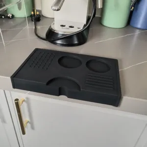 Silicone coffee tamper mat detail view, black corner coffee accessory pad with non-slip design.