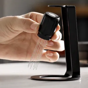 Detail view of stainless steel coffee distribution needle WDT tool with black stand holder.
