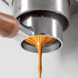 Bottomless espresso portafilter detail shot showing rich coffee extraction and crema flow.