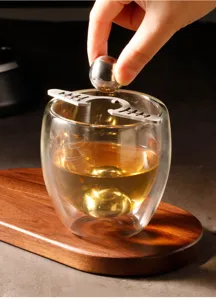 Stainless steel coffee ice ball holder and glass detail, perfect for espresso brewing.
