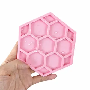 Pink silicone honeycomb coaster, non-slip drainage mat for kitchen, heat-resistant table pad.