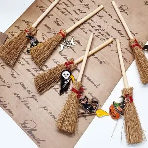 Detailed view of mini witch broom charms featuring cute Halloween decorations and wooden handles.