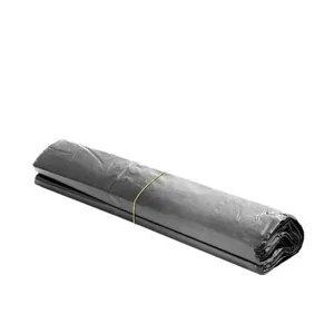 Close-up detail of a roll of black plastic garbage bags, durable material and compact roll.