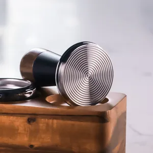 Walnut coffee tamper with stainless steel spiral base and wooden stand for espresso lovers.