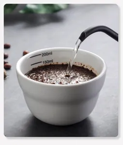 Professional ceramic coffee cupping cup detail view showing scale lines and brewing.
