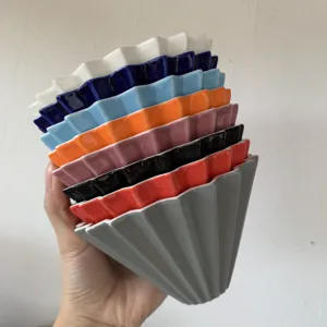Colorful ceramic origami coffee dripper cone pour over filter cup close up view
