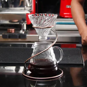 Detailed view of the glass pour over coffee dripper set with spiral copper stand.
