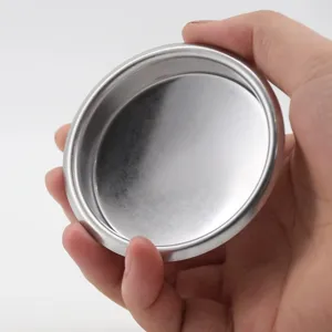 Detail shot of stainless steel coffee machine blind filter basket, backflush unholed disc close up.
