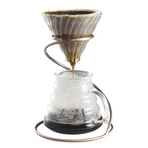 Glass coffee dripper and server set with stylish spiral metal stand for manual pour over brewing.