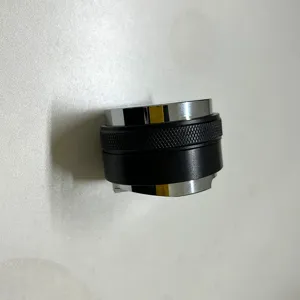 Coffee distributor detail view, adjustable dual head metal tamper with anti-slip grip.