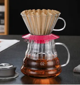 Glass coffee dripper and server set with paper filter for hand drip pour over coffee brewing.