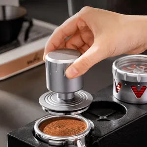 Stainless steel mini coffee tamper with double spring constant pressure and storage base.