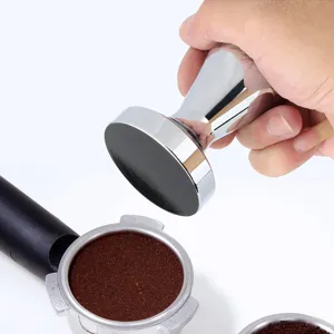 Stainless steel coffee tamper detail shot, professional espresso powder press tool close up