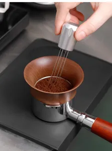Coffee needle distributor WDT tool with walnut dosing funnel and portafilter for espresso.