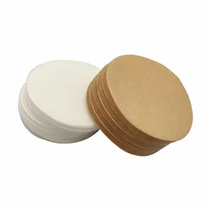 Close-up detail of round coffee filter paper stacks, white and brown paper for brewing.