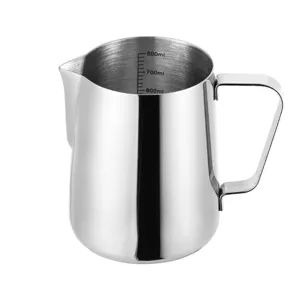 Stainless steel milk frothing pitcher detail showing clear internal volume measurement scale.