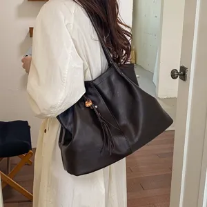 Minimalist leather tote bag showcasing daily commuter style, large capacity and side detail view.
