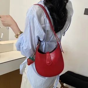 Stylish red hobo shoulder bag for women, minimalist PU leather saddle bag with strawberry charm.