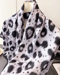 Black and white abstract leopard print silk scarf close-up detail shot elegant design.