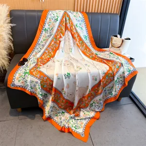 Vue détaillée d'un carré de soie de 130 cm avec motif lapin et fleurs, bordure orange.