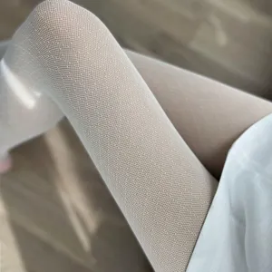 Close up detail shot of textured diamond pattern sheer pantyhose for women summer thin legs