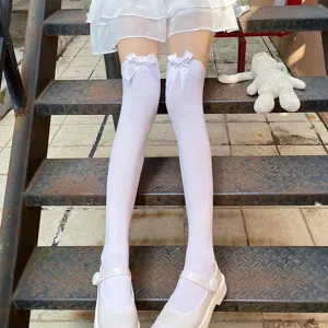 White over-the-knee socks for women featuring sweet bow details, cute Lolita style hosiery.