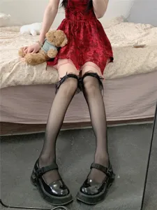 Διαφανείς μαύρες κάλτσες Lolita με λεπτή δαντελωτή μπορντούρα και χαριτωμένους φιόγκους.