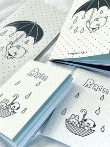 Detailed close-up of cute travel passport notebooks with polka dot covers and illustrations.