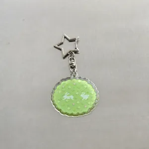 Cute pixel art acrylic keychain for journal planner, green rabbit design bag charm accessory.