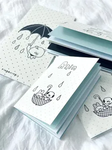 Detailed shot of cute cartoon character traveler notebooks featuring dotted covers and papers.