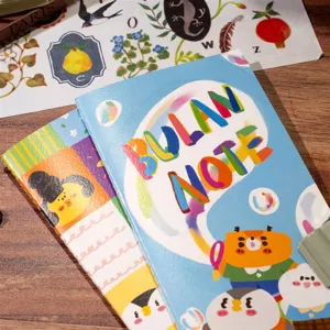 Close-up detail of Bulan original TN notebook and release book cover with cute illustration.
