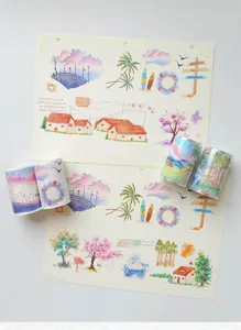 Detailed closeup of watercolor scenery washi tape rolls and design sheets for daily journaling.