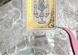 Close-up of vintage gold foil stamp sticker detail, elegant stationery crafting supply.