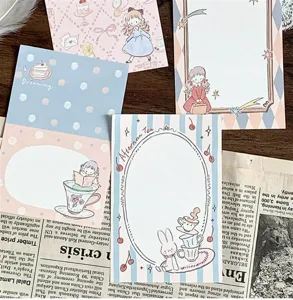 Detailed shot of vintage aesthetic journaling stickers and memo pads with cute illustrations.