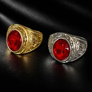 Detailed view of vintage wide band men rings with oval red gem inlay and intricate carvings.