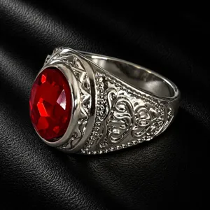Vintage men's wide silver ring with a bold red oval gemstone and intricate carved details.