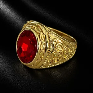 Detailed view of vintage gold men's statement ring featuring a bold red oval gemstone.