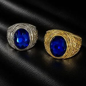 Close-up of retro carved wide men rings with large oval blue synthetic gemstones.
