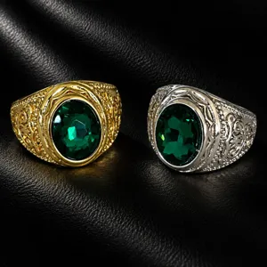 Detailed close-up of retro men's wide rings with oval green stones and intricate carvings.