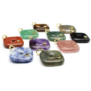 Detail shot of multi-color natural stone square pendants with gold-plated bails and sparkling inlaid zircons.