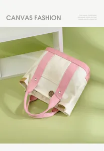 Canvas tote handbag with pink handles, stylish commuter bag for women for daily use.