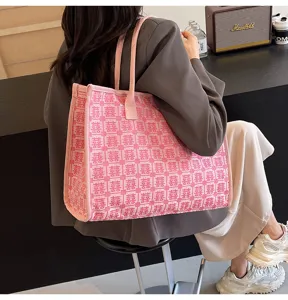 Detailed view of pink knit tote bag featuring double happiness pattern for wedding styling.