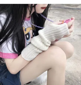 Detailed view of white knitted arm warmers, ribbed texture, stylish Harajuku accessory.