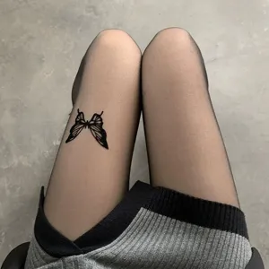 Black sheer pantyhose with butterfly print detail, sexy Y2K style hosiery for women.
