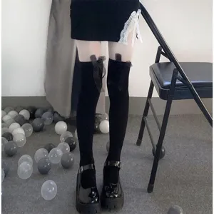 JK Lolita black over-the-knee socks with cute bows, paired with white stockings detail shot.