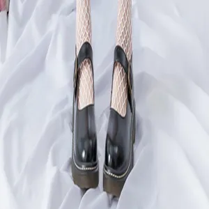 Stylish black Mary Jane shoes paired with white fishnet stockings for women detail shot.