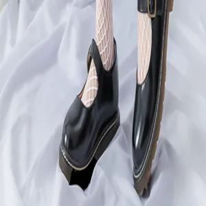 Detail view of women's white fishnet tights paired with classic black Mary Jane shoes.