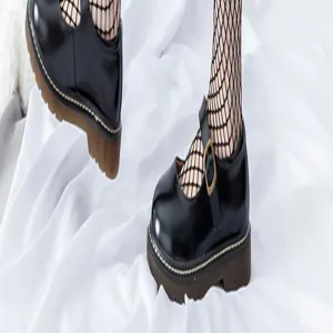 Detailed view of fashionable black fishnet stockings paired with classic platform shoes.
